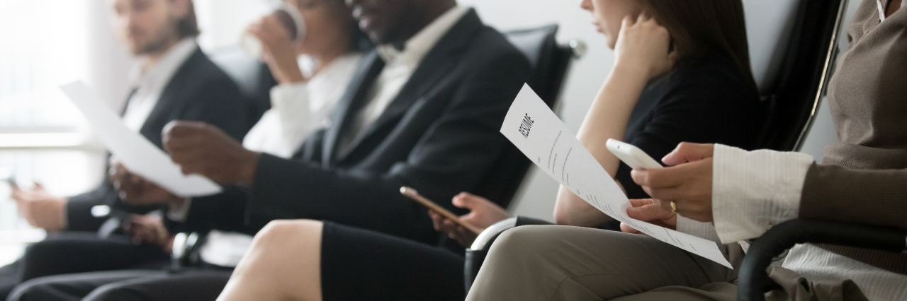 Horizontal side photo multinational applicants businesspeople sitting in queue waiting job interview holding resume papers using mobile phones, hr employment concept, banner for website header design; Shutterstock ID 1289836282; purchase_order: -; job: -; client: -; other: -